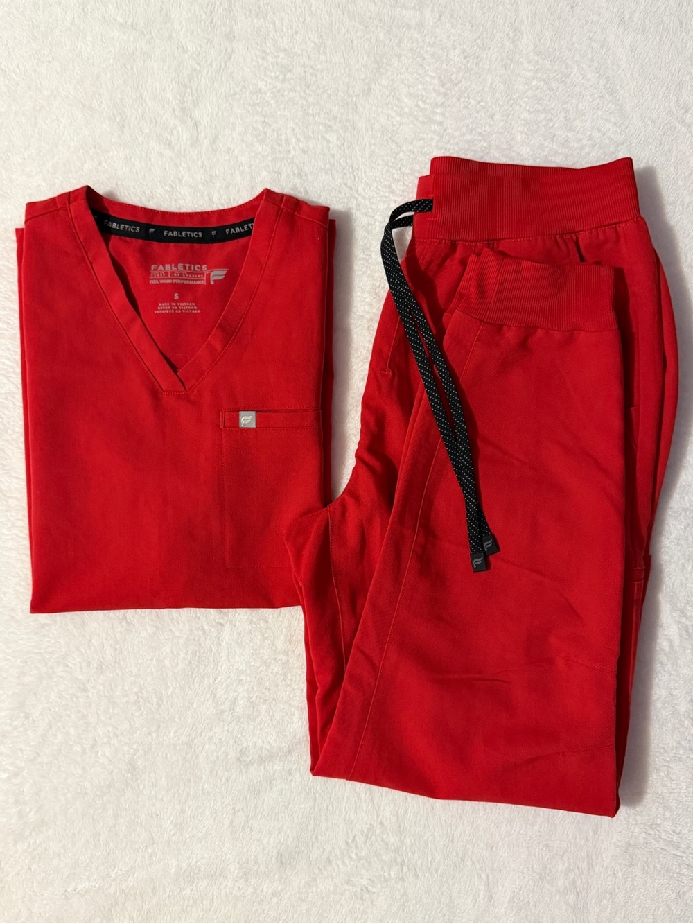 Fabletics scrubs set in Goji Red